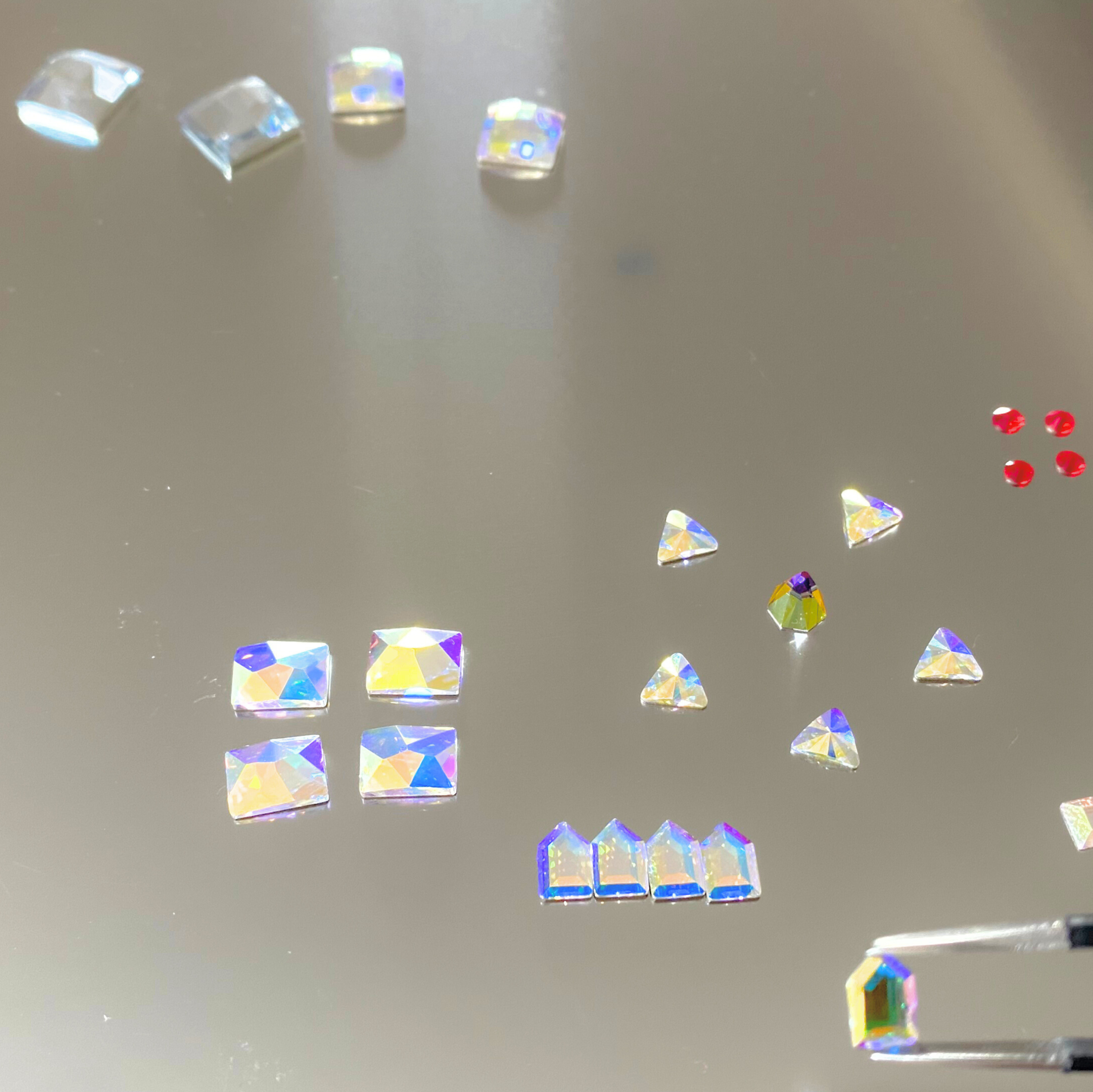 Colorful crystal-like objects on a reflective surface